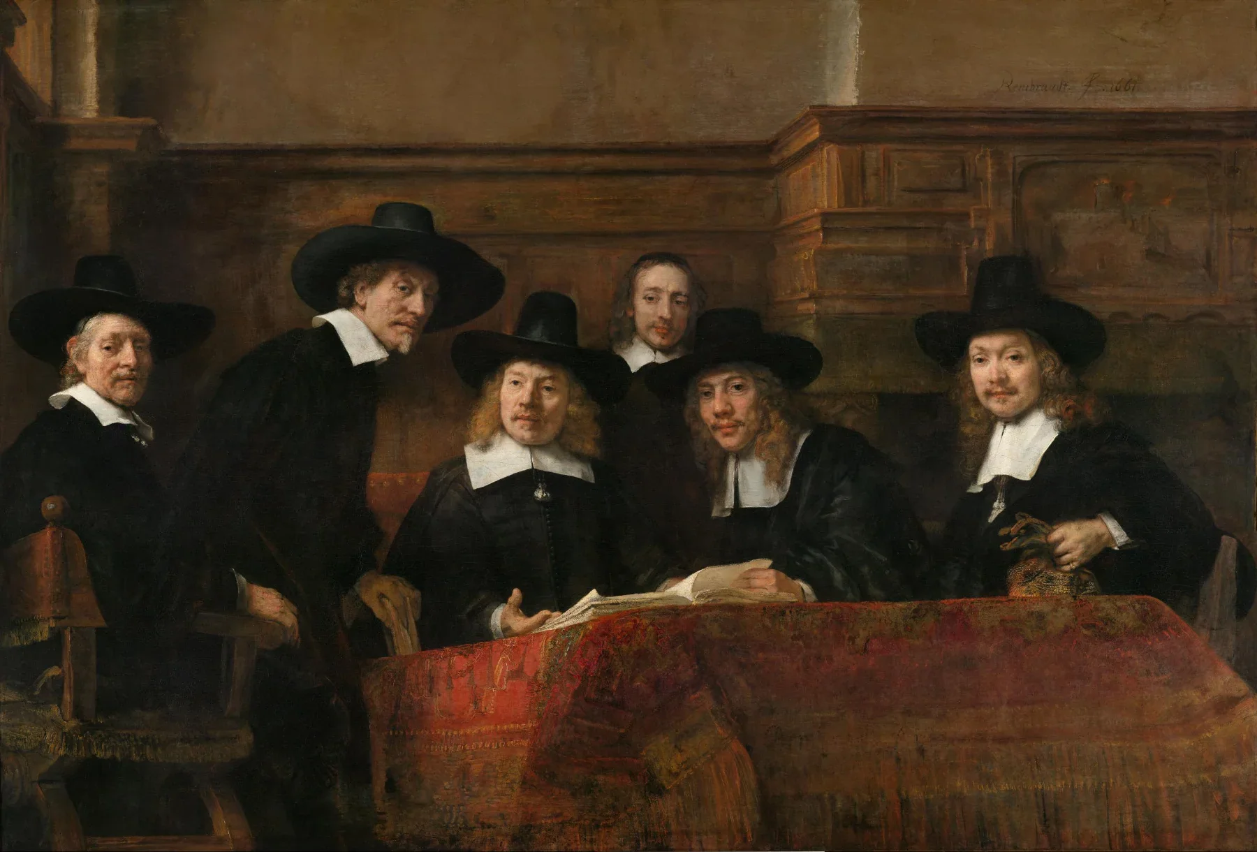 Rembrandt'ın grup portresinde siyah giysili beş kumaş loncası görevlisi ve hizmetkârları kırmızı desenli halıyla örtülü masadaki açık kitaptan başlarını kaldırıyor.
