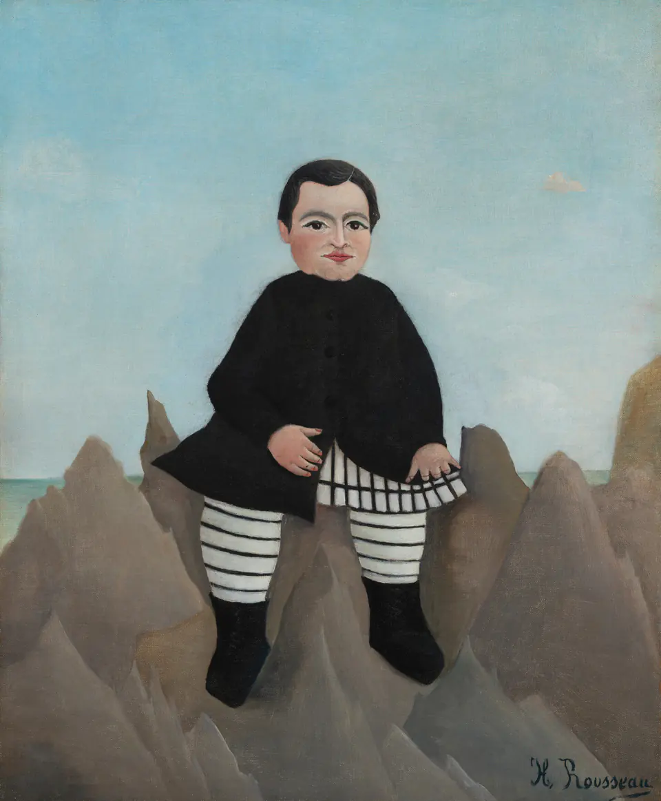 A solemn boy in a black jacket sits monumentally on pointed rocks beneath a blue sky