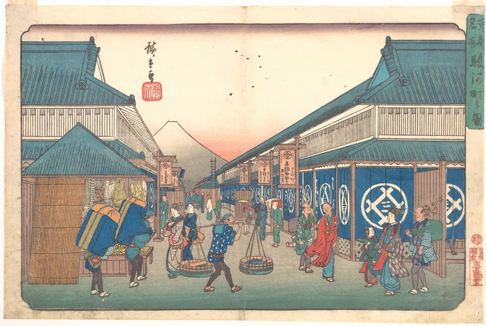 Merchants and pedestrians on Suruga Street with Mount Fuji centred between buildings