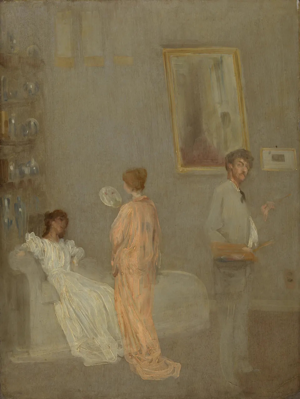 Whistler standing with palette and brush among scrolls and porcelain in his studio