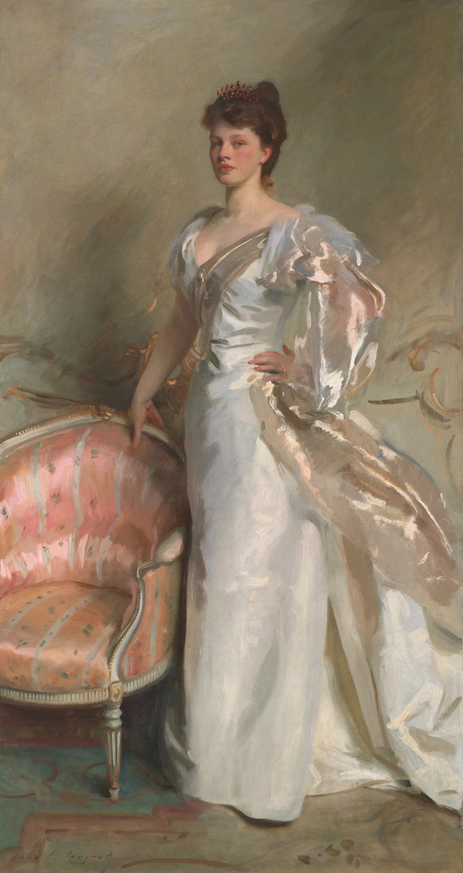 Elizabeth Ebsworth Swinton standing in a shimmering white dress beside a coral chair