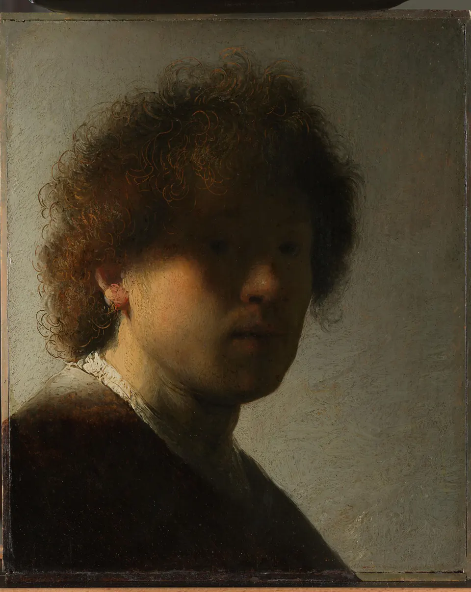 Rembrandt portraying himself as the Apostle Paul, holding a manuscript and sword hilt