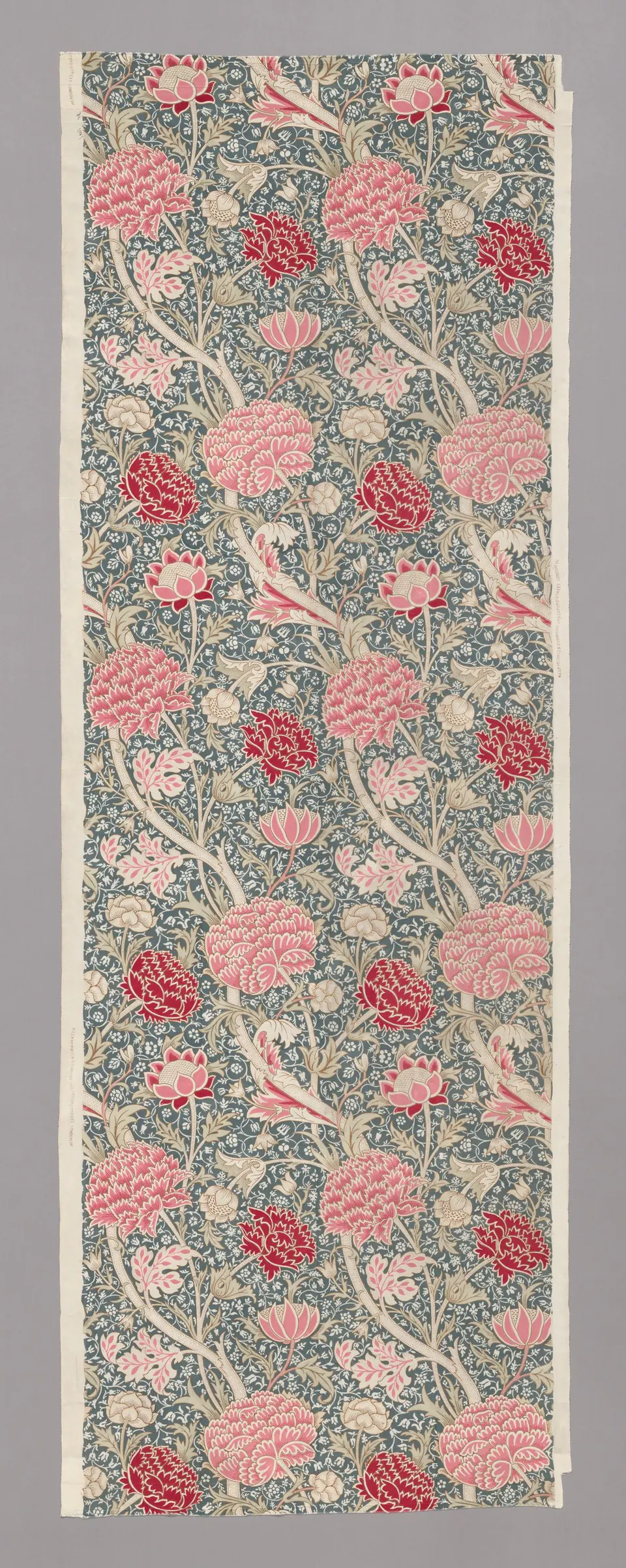 A long block-printed Cray textile with layered flowers and scrolling leaves by William Morris