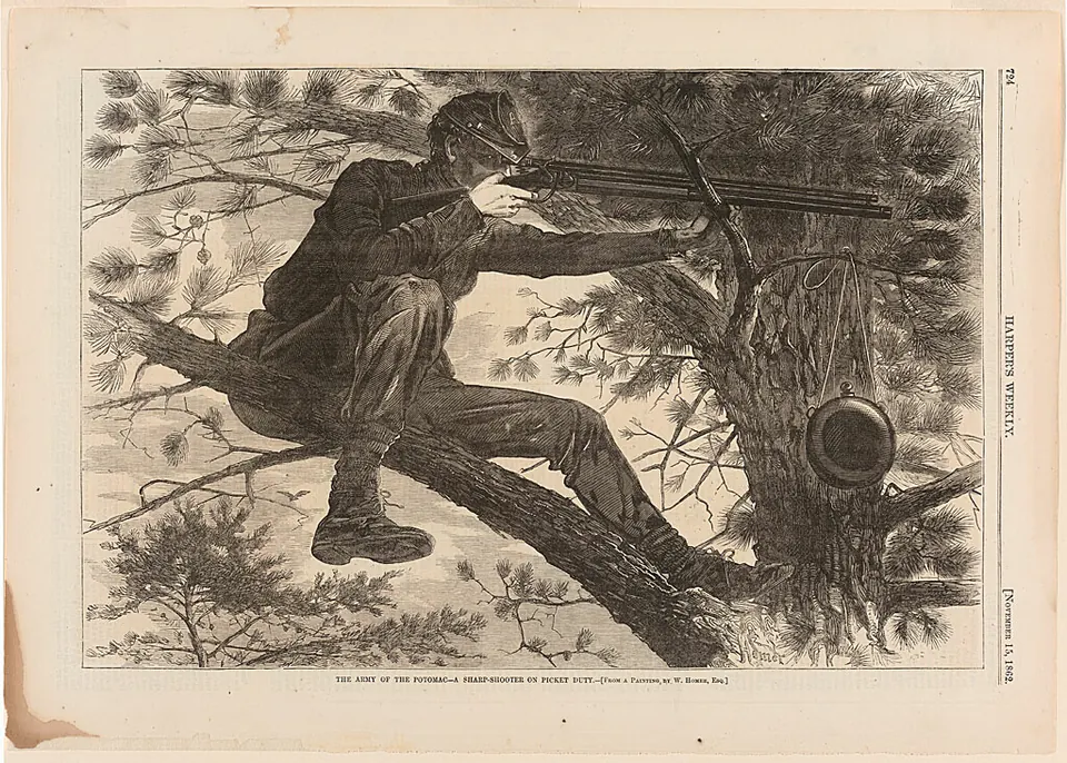 A Civil War sharpshooter lying along a tree branch and aiming a rifle