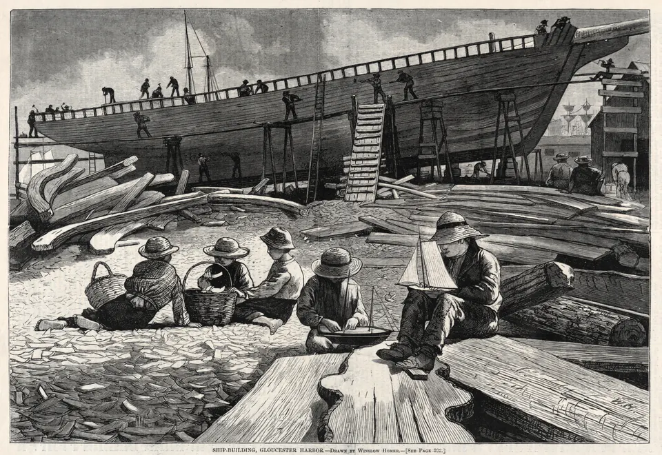 Children watching workers build a wooden ship beside Gloucester Harbor