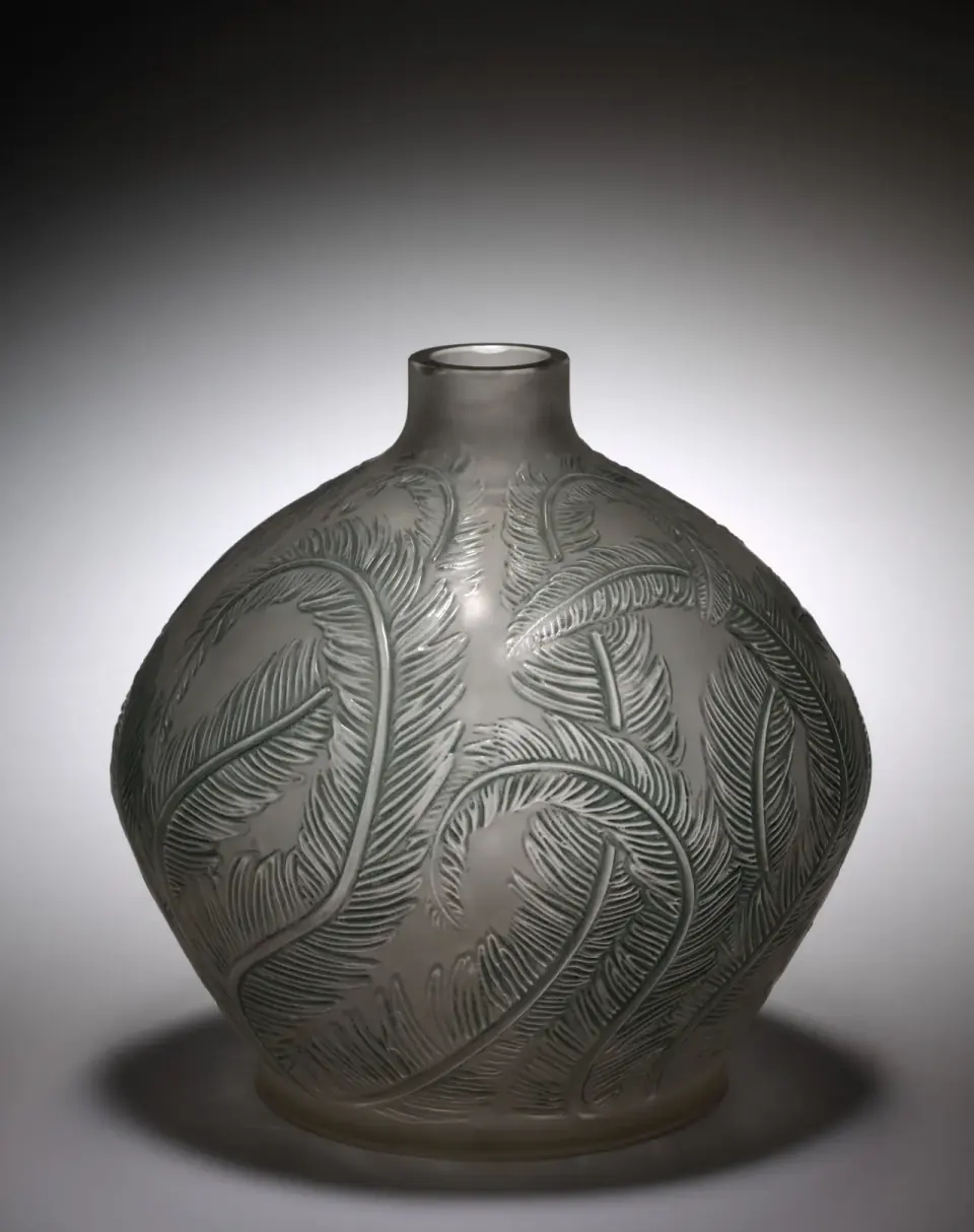 René Lalique’s rounded glass Plumes vase has overlapping feather forms in relief and a short circular neck