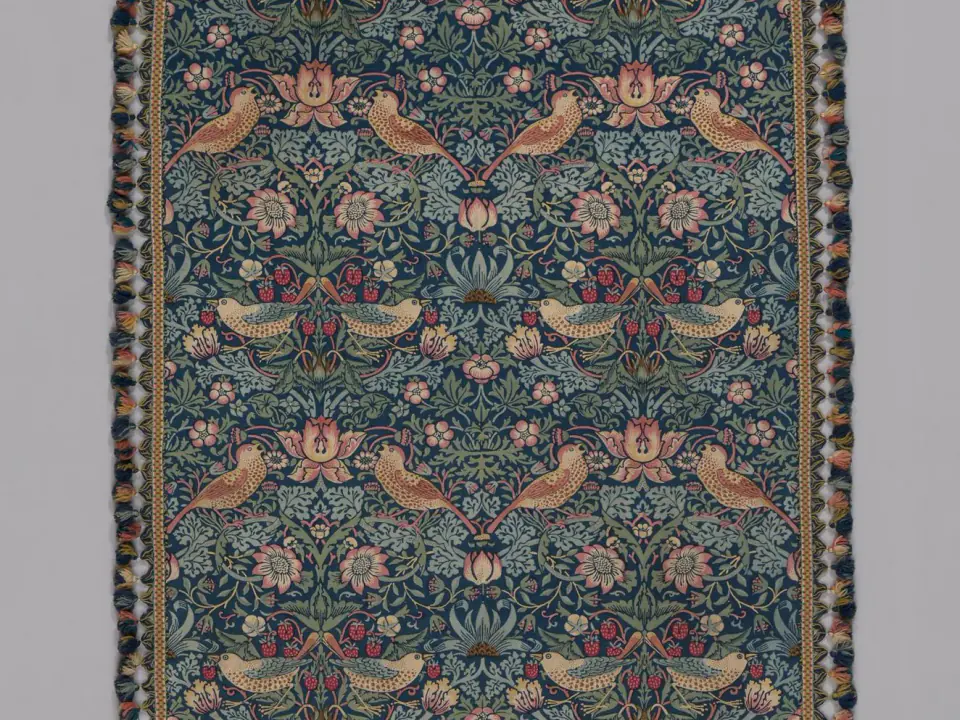 William Morris's Strawberry Thief textile, with repeated birds among flowers and fruit on a dark ground