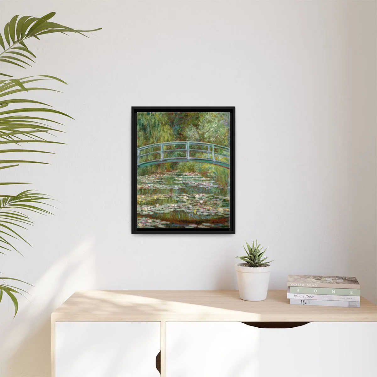 Digital styling mockup of Monet’s Bridge over a Pond of Water Lilies: framed canvas in a room, 16 by 20 inches.